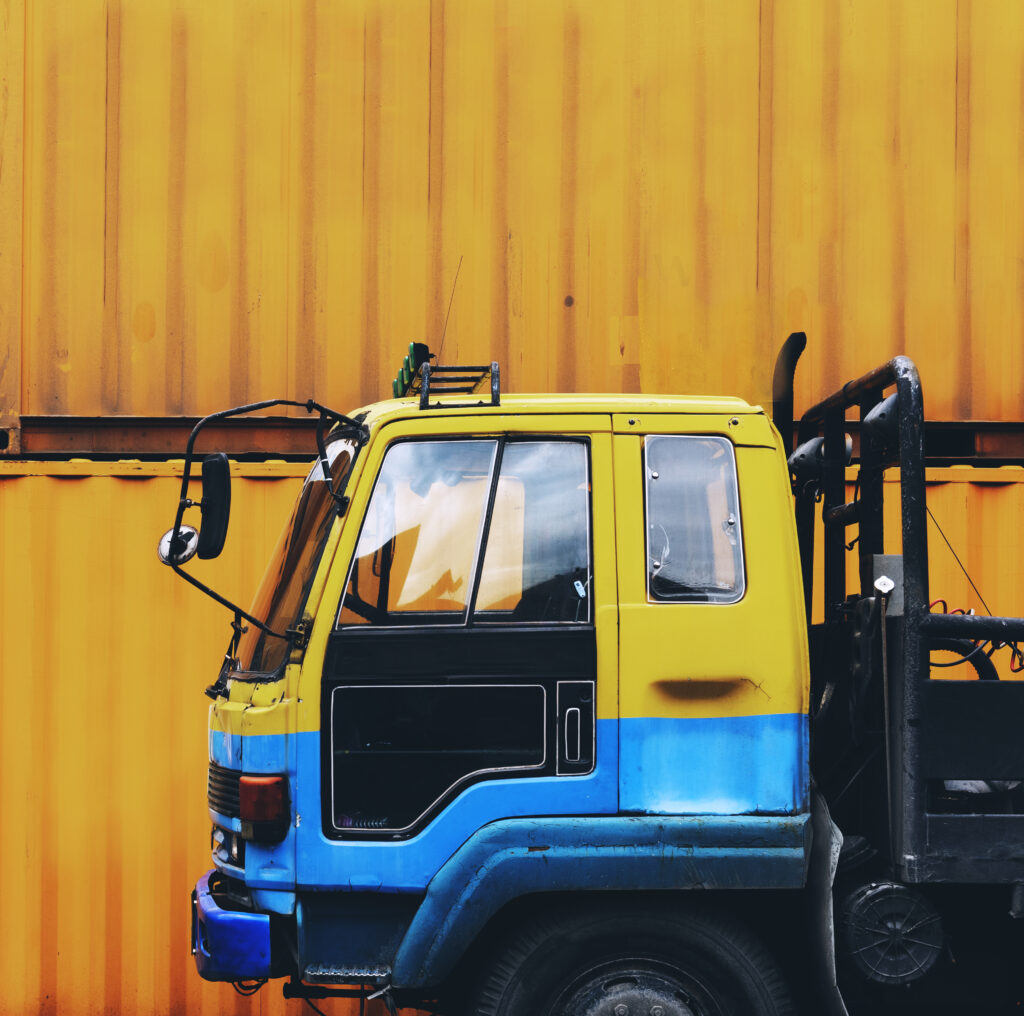 yellow truck parked near a yellow container box